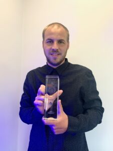 Tom Howarth Head of Customer Support with the trophy SB Software thrilled after win at The Vendies
